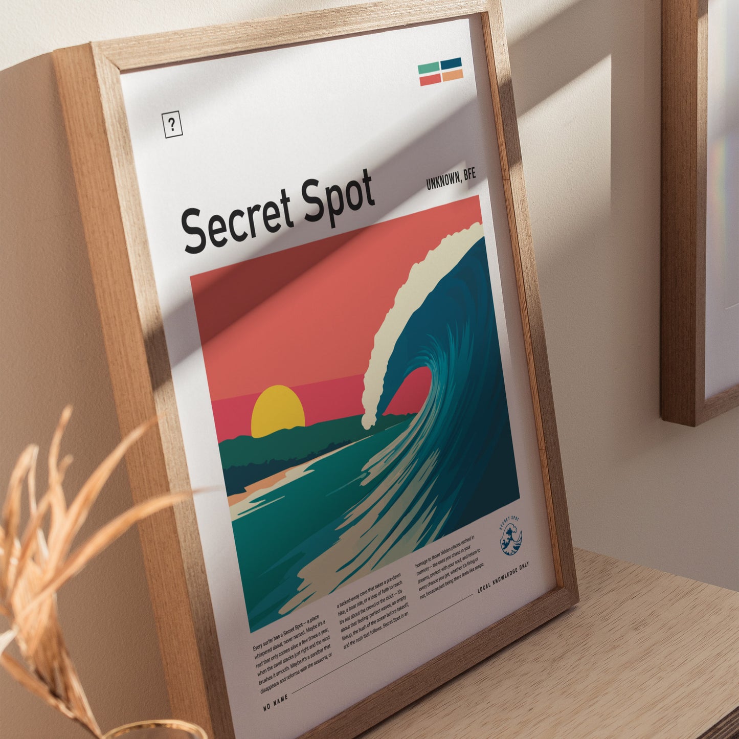 A framed poster titled Secret Spot features a vibrant illustration of a wave curling under a sunset, with pastel skies in the background. The artwork celebrates surf culture and hidden surf spots, presented with a clean, modern design.