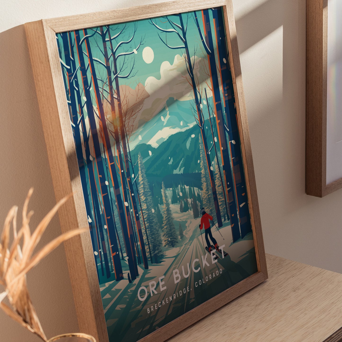 Framed poster featuring a skier in a red jacket navigating through snow-covered trees against a mountainous backdrop under a bright sky, labeled Ore Bucket Breckenridge, Colorado.