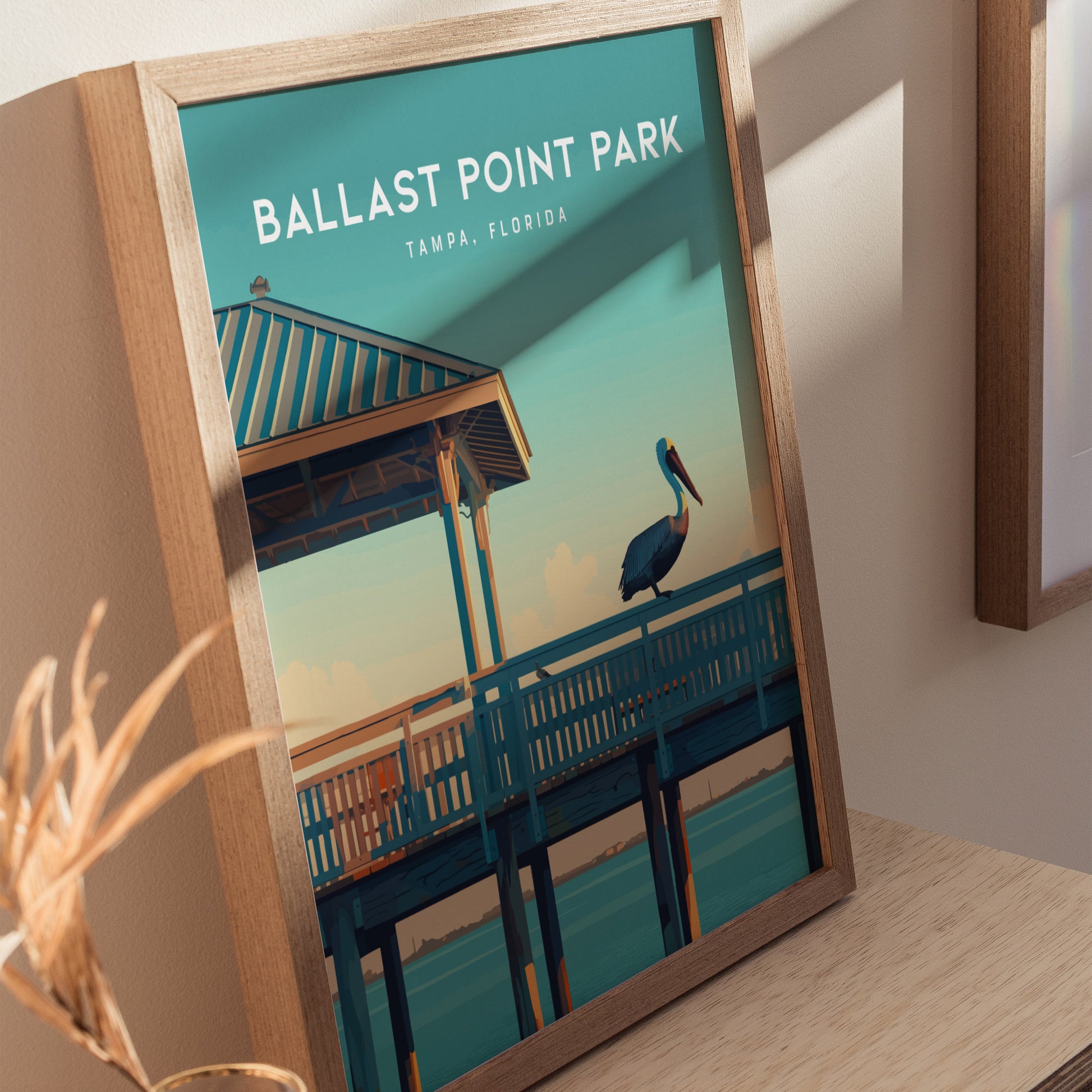 Framed poster of Ballast Point Park, Tampa, Florida, featuring a pelican on a fishing pier under a blue sky.