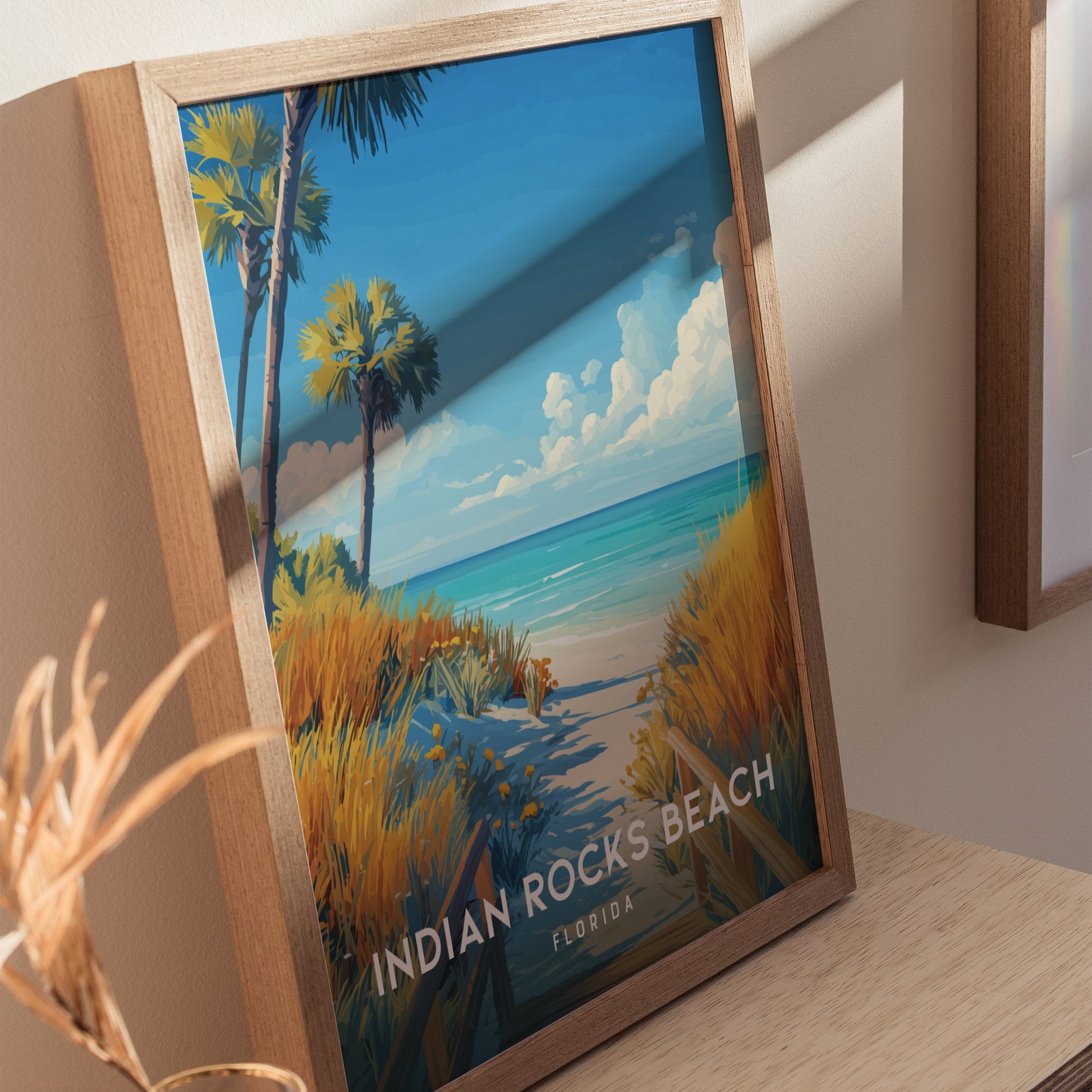 Home decor showing framed and unframed wall art depicting a serene boardwalk and turquoise waters at Indian Rocks Beach.