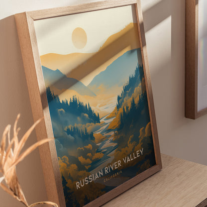 Framed poster of Russian River Valley, featuring stylized blue and golden rolling hills with a sun in the background, displayed on a wooden surface.
