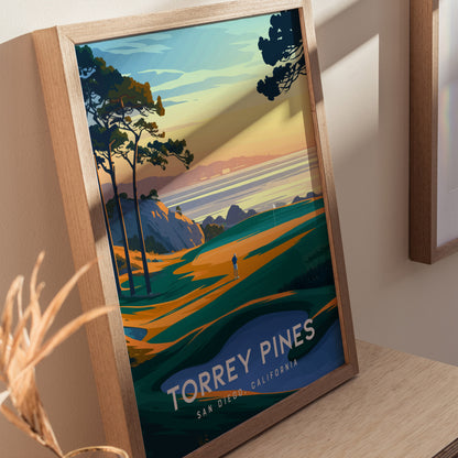 Framed poster of Torrey Pines Golf Course featuring vibrant coastal cliffs, trees, and a figure on a fairway at sunset. Text reads Torrey Pines, San Diego, California.