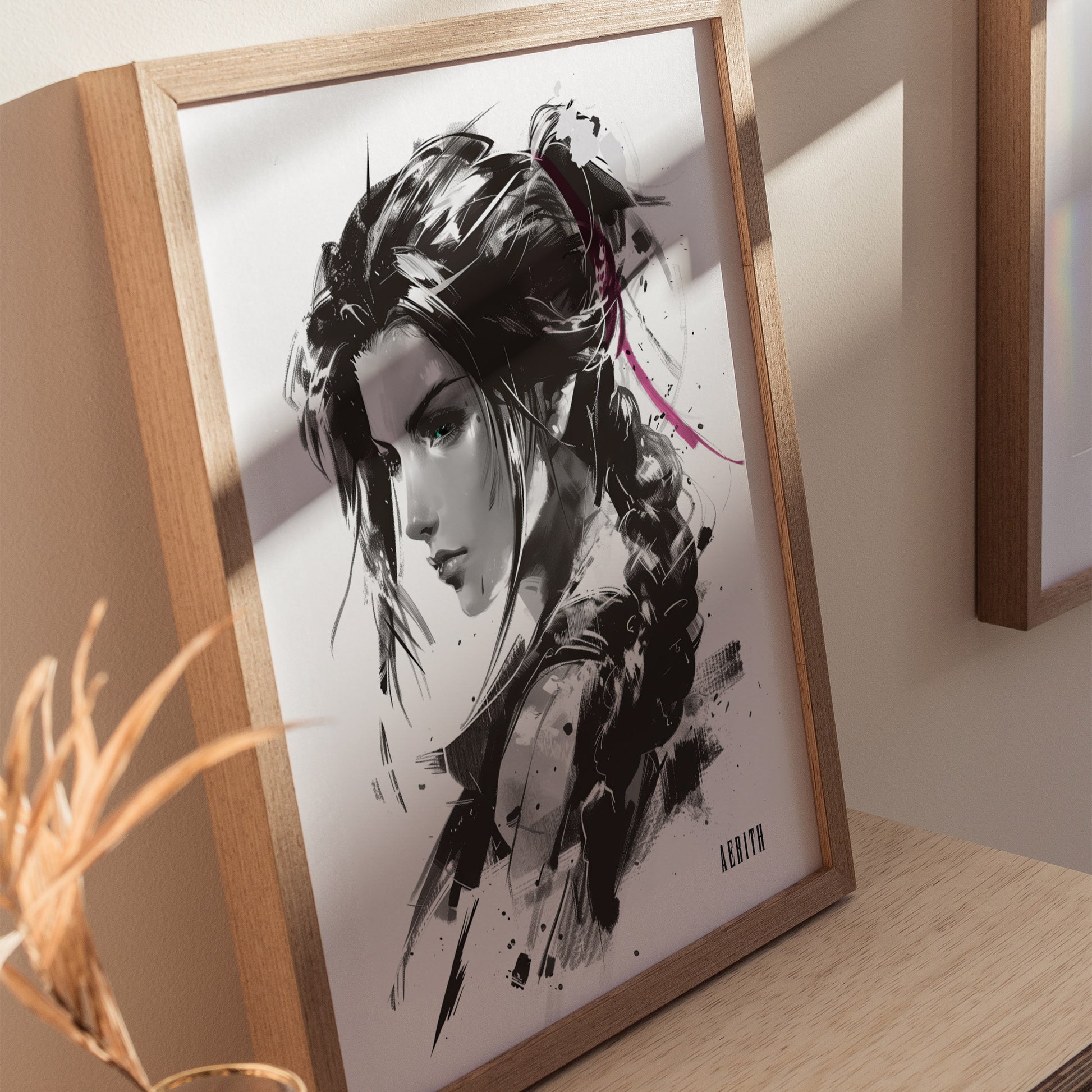 A framed monochrome portrait of a woman with braided hair, accented by a pink ribbon, styled with expressive ink strokes, displayed on a wooden surface. Shadows cast across the artwork.
