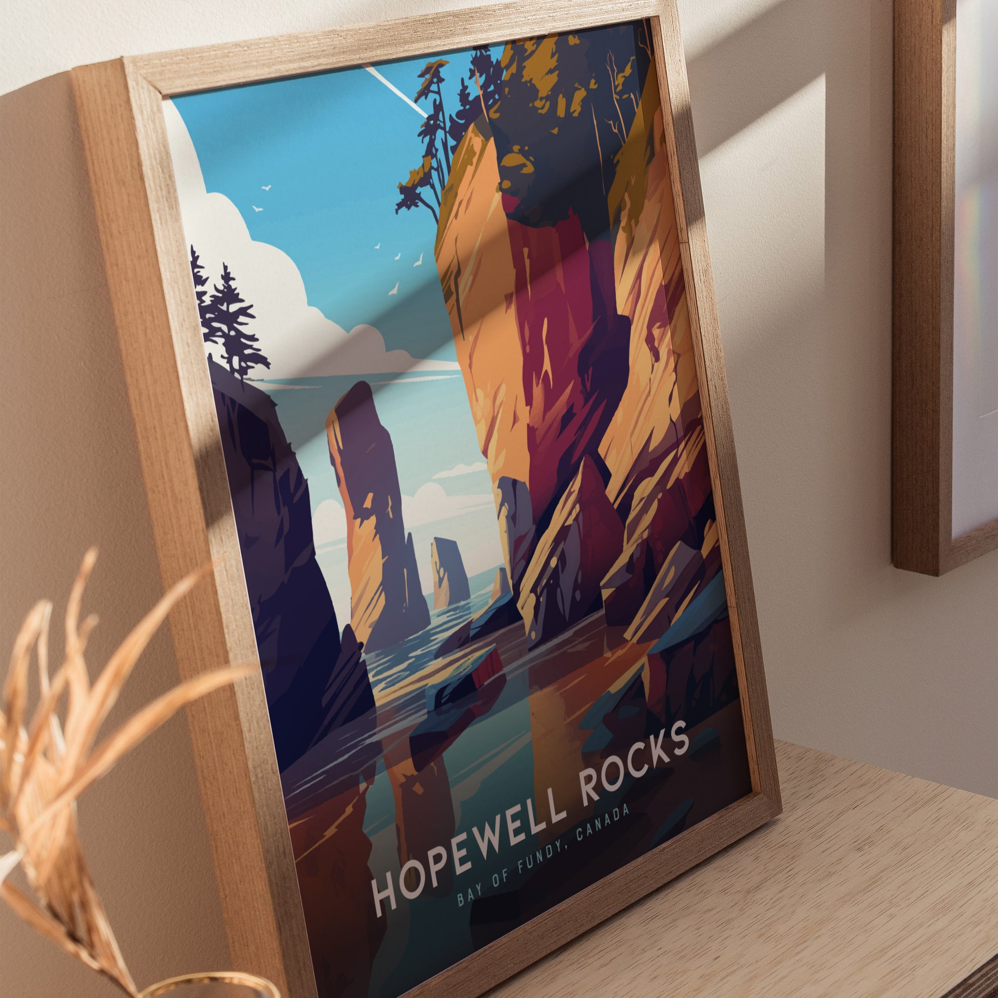 Framed poster of Hopewell Rocks showcases vibrant, stylized cliffs and seascape under a blue sky. The text reads Hopewell Rocks, Bay of Fundy, Canada.