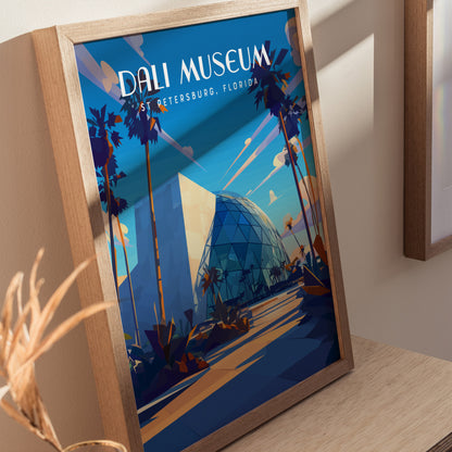 A framed poster of the Dali Museum featuring geometric architecture and palm trees, set against a vibrant blue sky. The text reads Dali Museum, St. Petersburg, Florida.