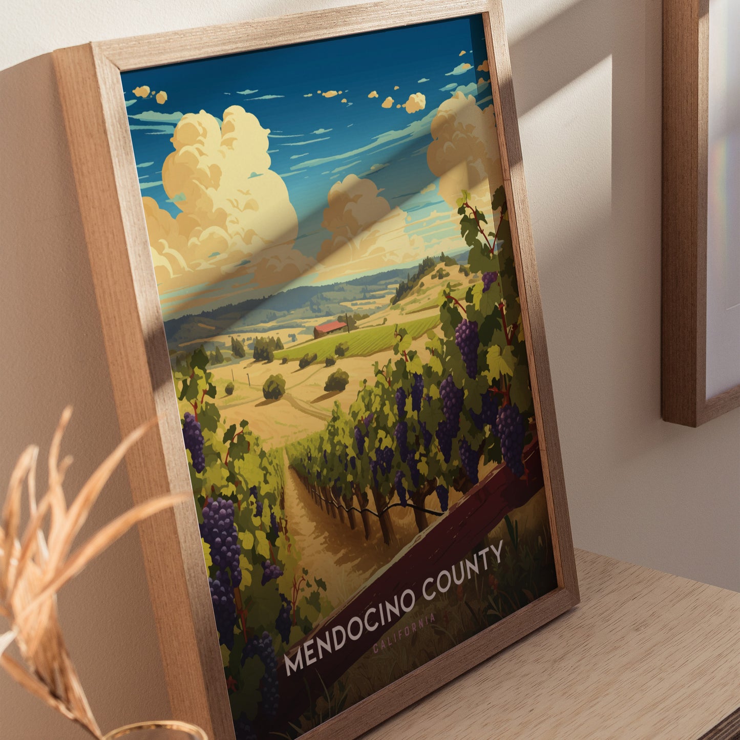 Framed Mendocino County poster depicting a vineyard with rolling hills and a blue sky with clouds, showcasing a scenic view of Californias wine country.