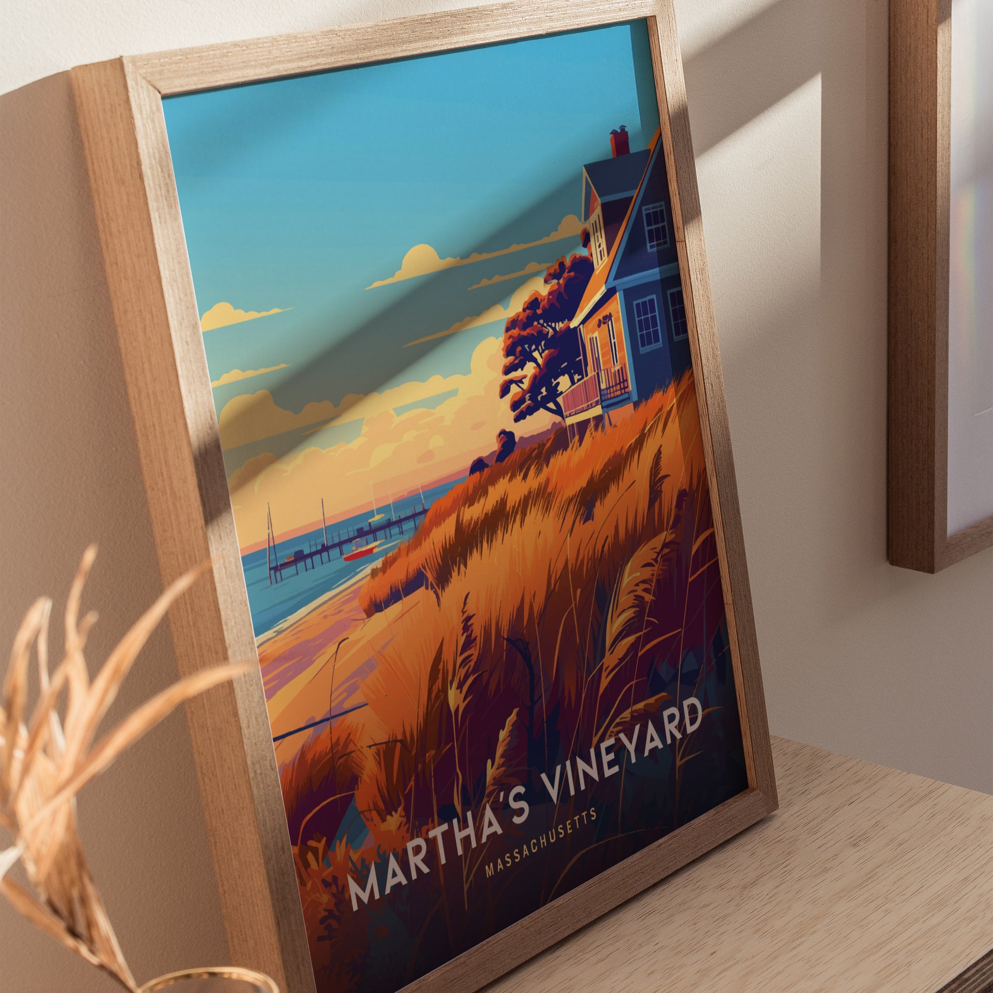 Framed poster featuring a coastal scene with a house, golden grasses, and sailboats at sunset, labeled Marthas Vineyard Massachusetts. The artwork evokes a serene, picturesque New England landscape.