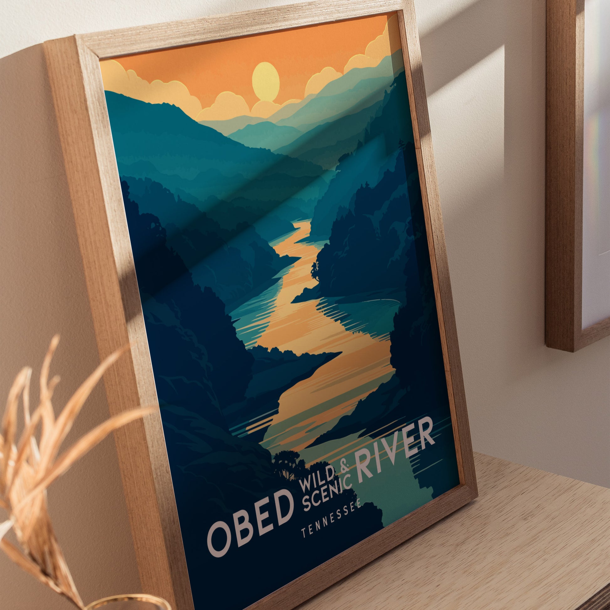 Framed poster depicting a scenic river winding through blue and green hills under an orange sunset, titled OBED WILD & SCENIC RIVER TENNESSEE.