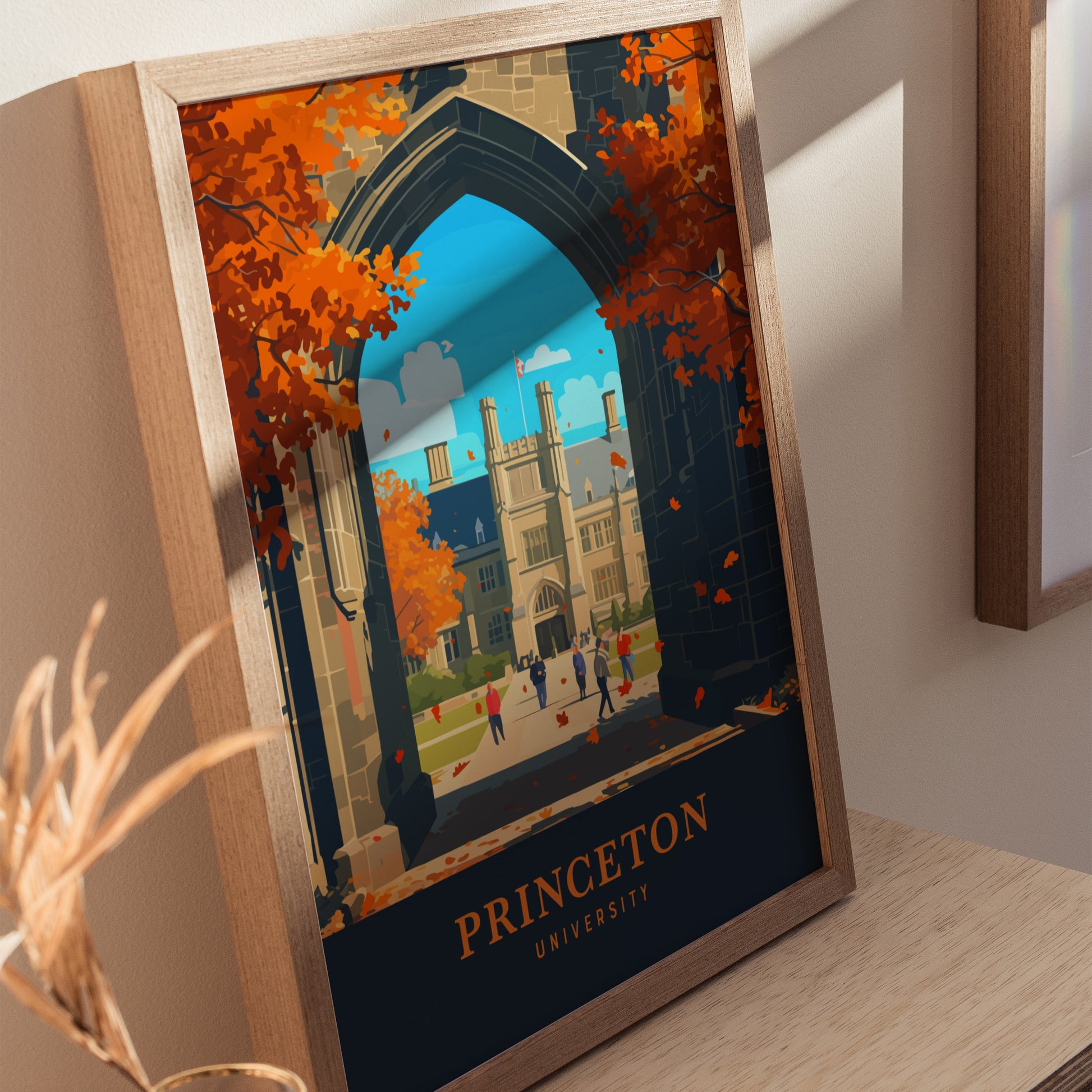 Framed artwork depicting Princeton University with Gothic architecture, vibrant autumn trees, and people walking on campus. The poster includes the text Princeton University at the bottom.