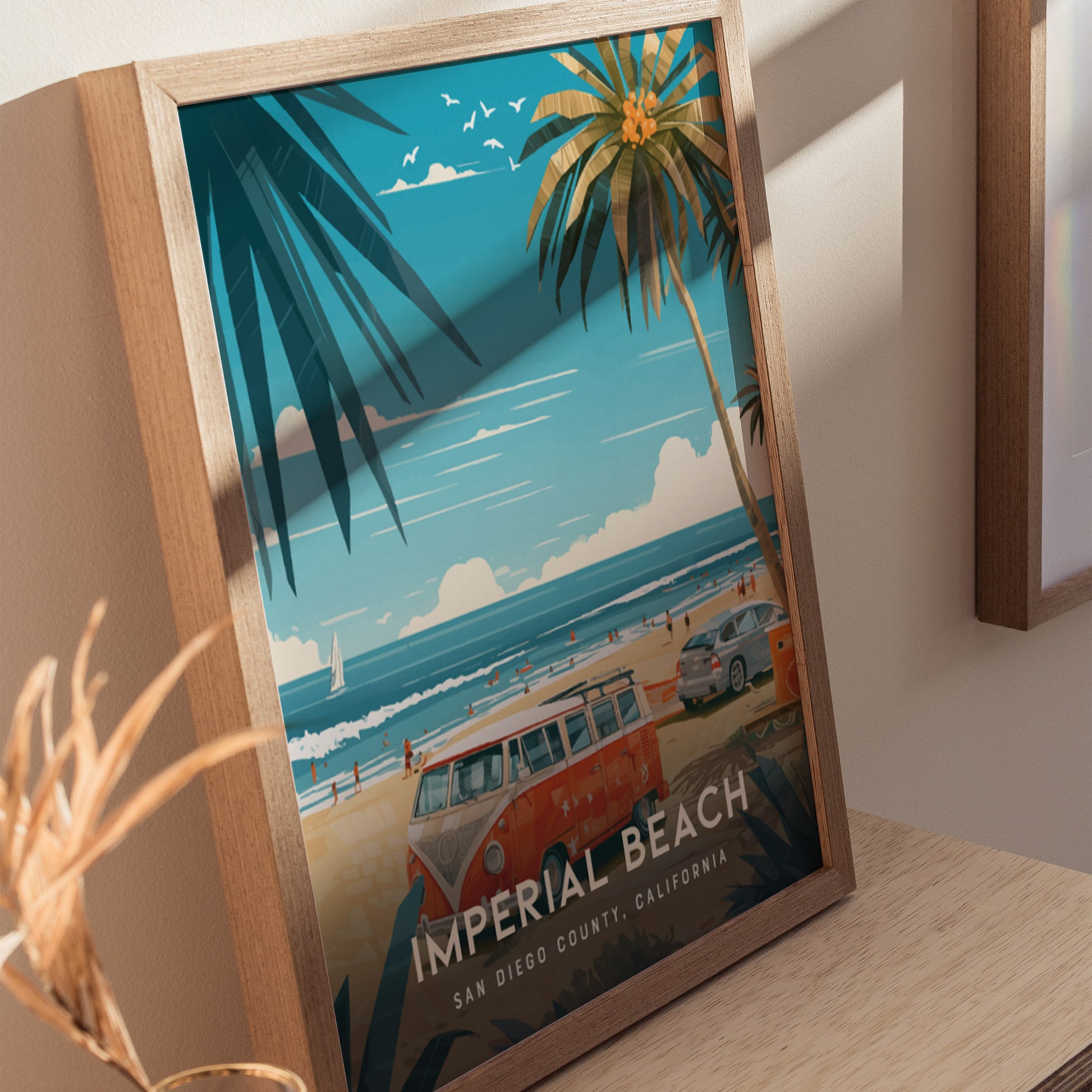 Framed artwork showcasing a vibrant beach scene with palm trees, a vintage van, and ocean waves under a blue sky. Text reads Imperial Beach, San Diego County, California.
