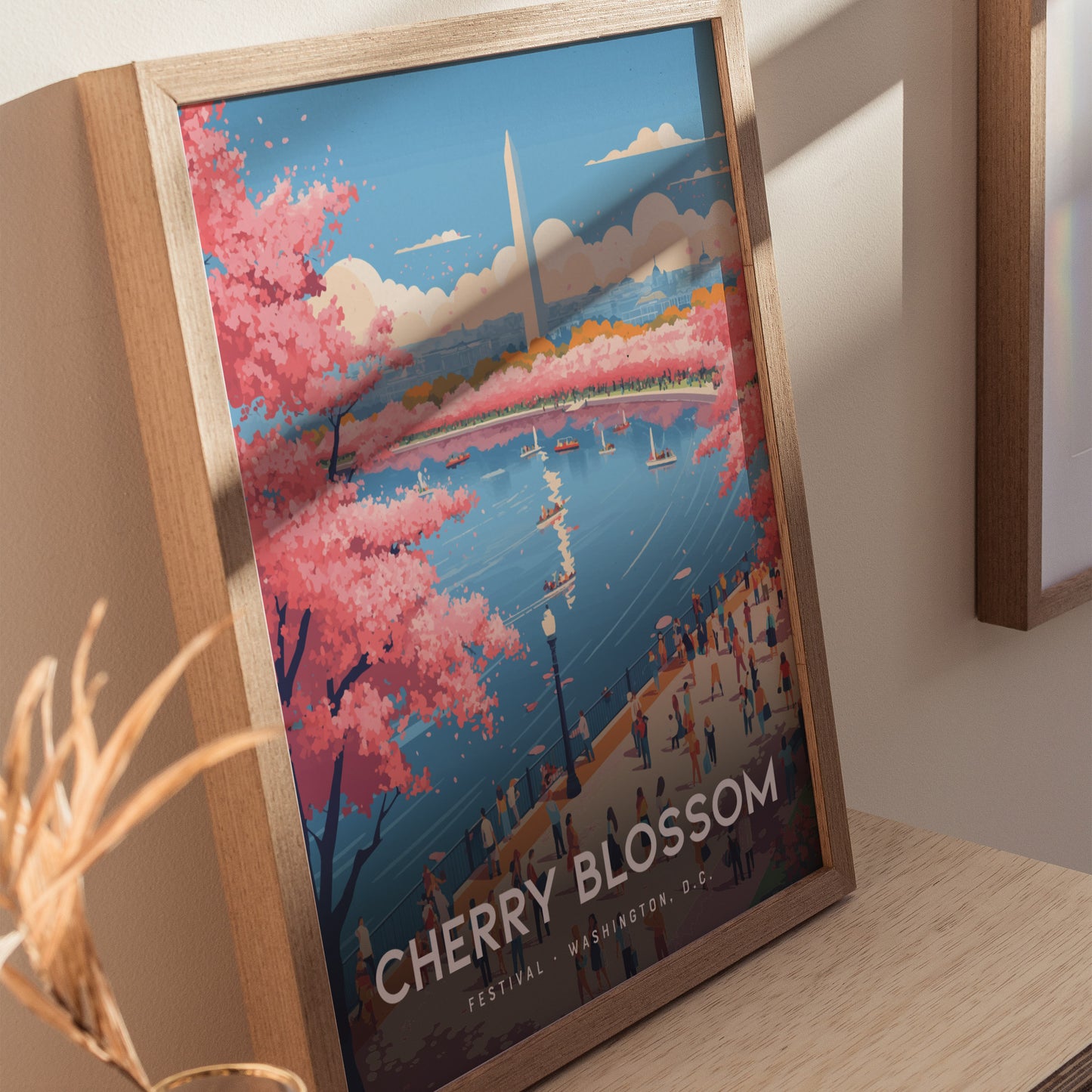 Framed poster featuring a vibrant illustration of Washington D.C.s cherry blossoms in full bloom around a water body, with the Washington Monument in the background. People are strolling along the path, enjoying the scenic view.