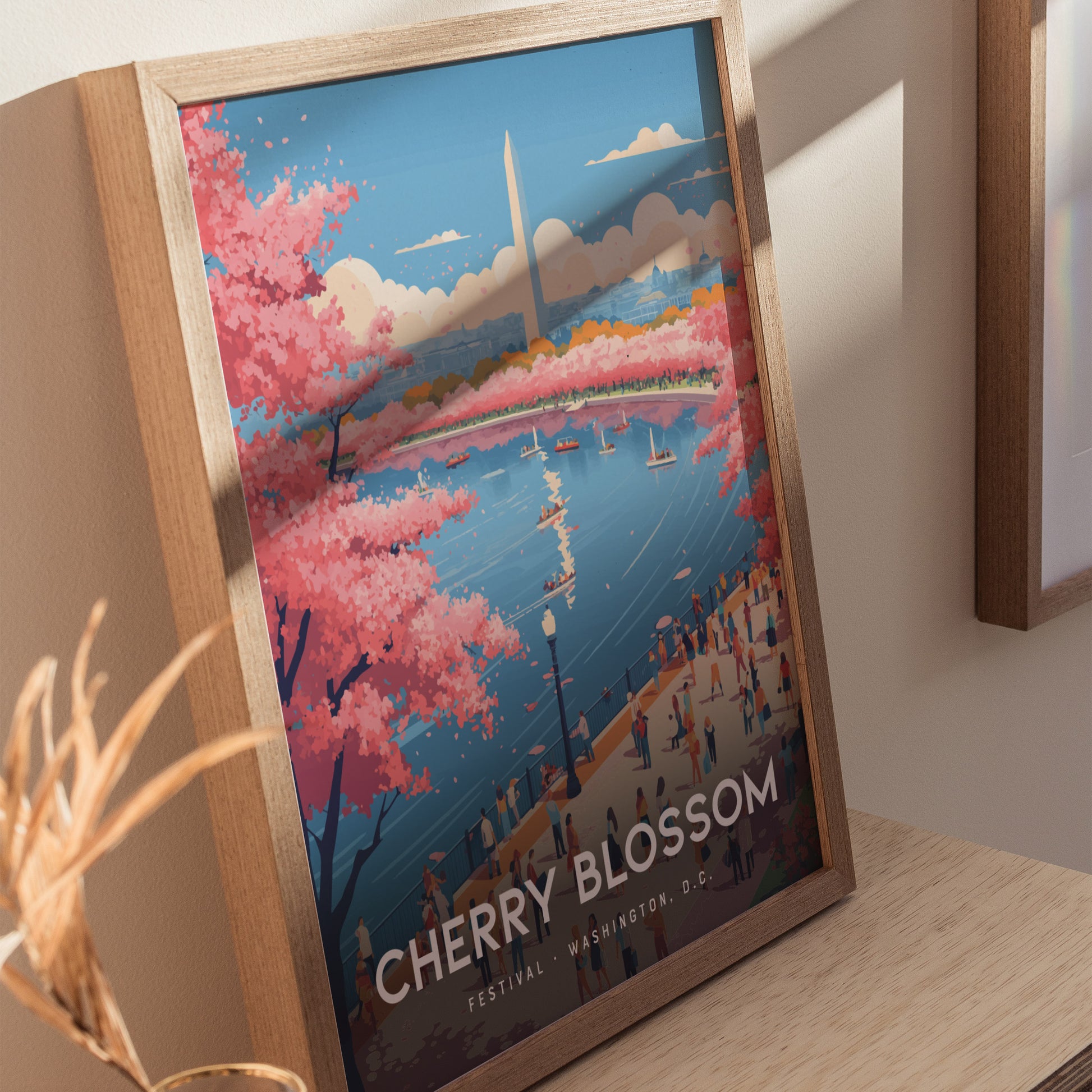 Framed poster featuring a vibrant illustration of Washington D.C.s cherry blossoms in full bloom around a water body, with the Washington Monument in the background. People are strolling along the path, enjoying the scenic view.