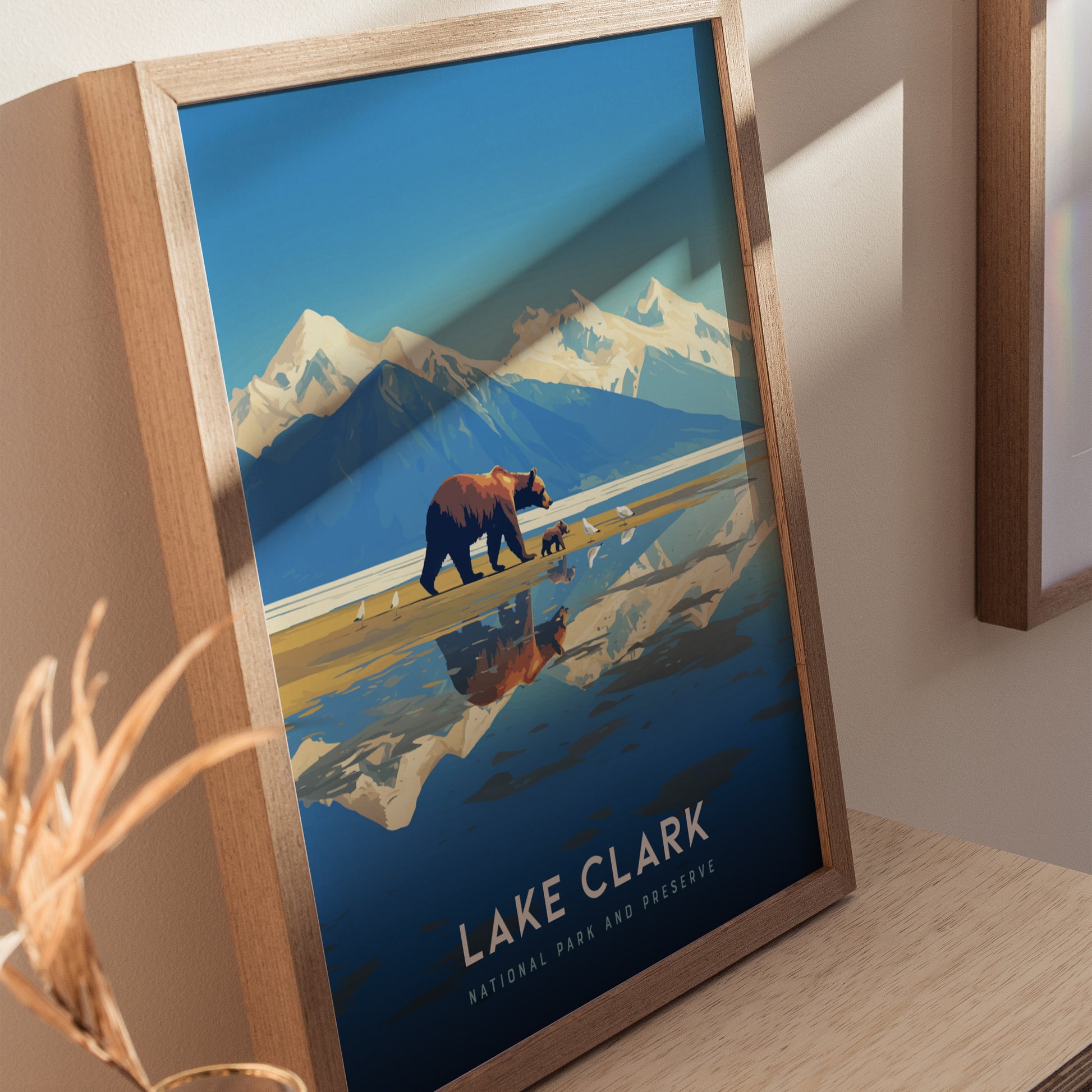 Framed Lake Clark National Park poster featuring a bear and cub walking along a reflective turquoise lake with snow-capped mountains in the background.