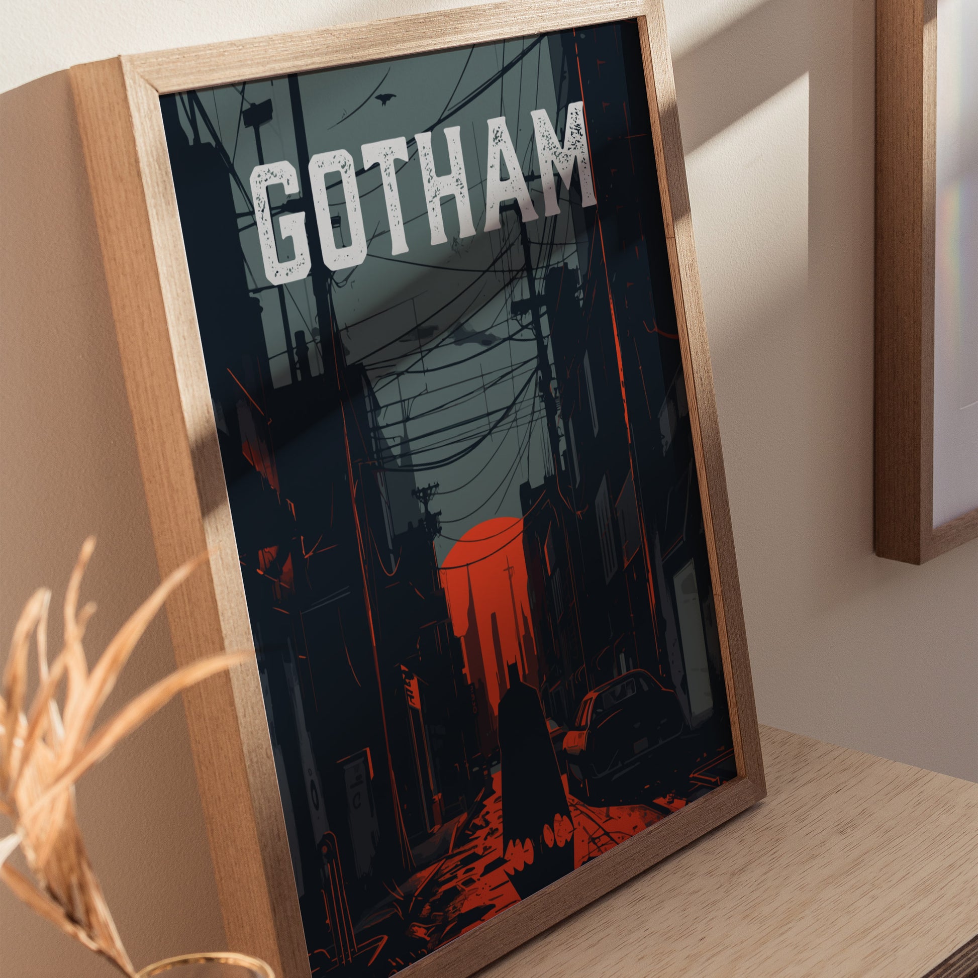A framed poster depicting a dark, atmospheric alleyway in Gotham City with the silhouette of a figure in a cape. The word GOTHAM is prominently displayed at the top, with red and gray tones highlighting the noir style.