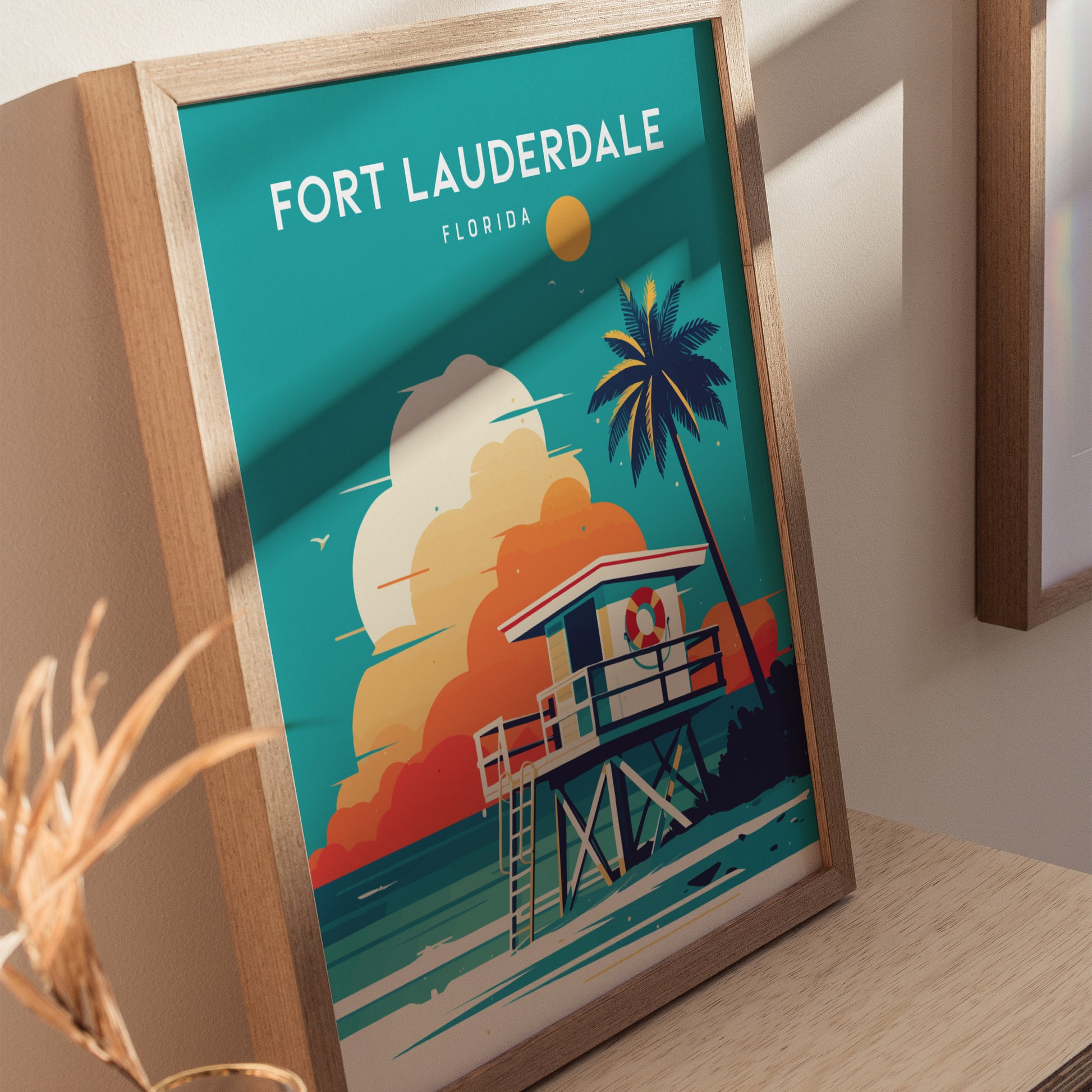 Framed Fort Lauderdale poster featuring a lifeguard stand, palm tree, and vibrant sunset over the ocean. The minimalist design evokes a tranquil Florida beach scene.