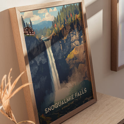 A framed poster of Snoqualmie Falls in Washington shows a vibrant waterfall cascading through forested cliffs, with a lodge visible. The artwork is displayed on a wooden surface.