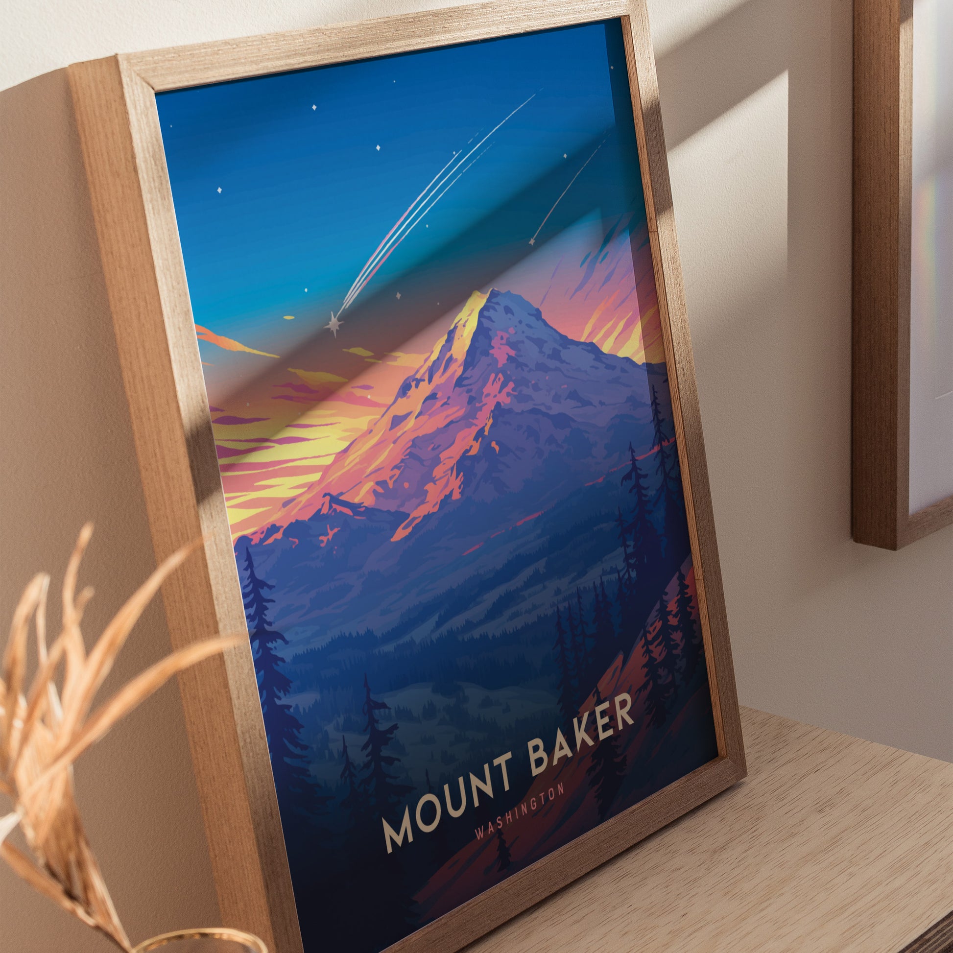 A framed poster of Mount Baker features a colorful depiction of the mountain with a vibrant sunset and shooting stars in the sky, creating a striking visual centerpiece.
