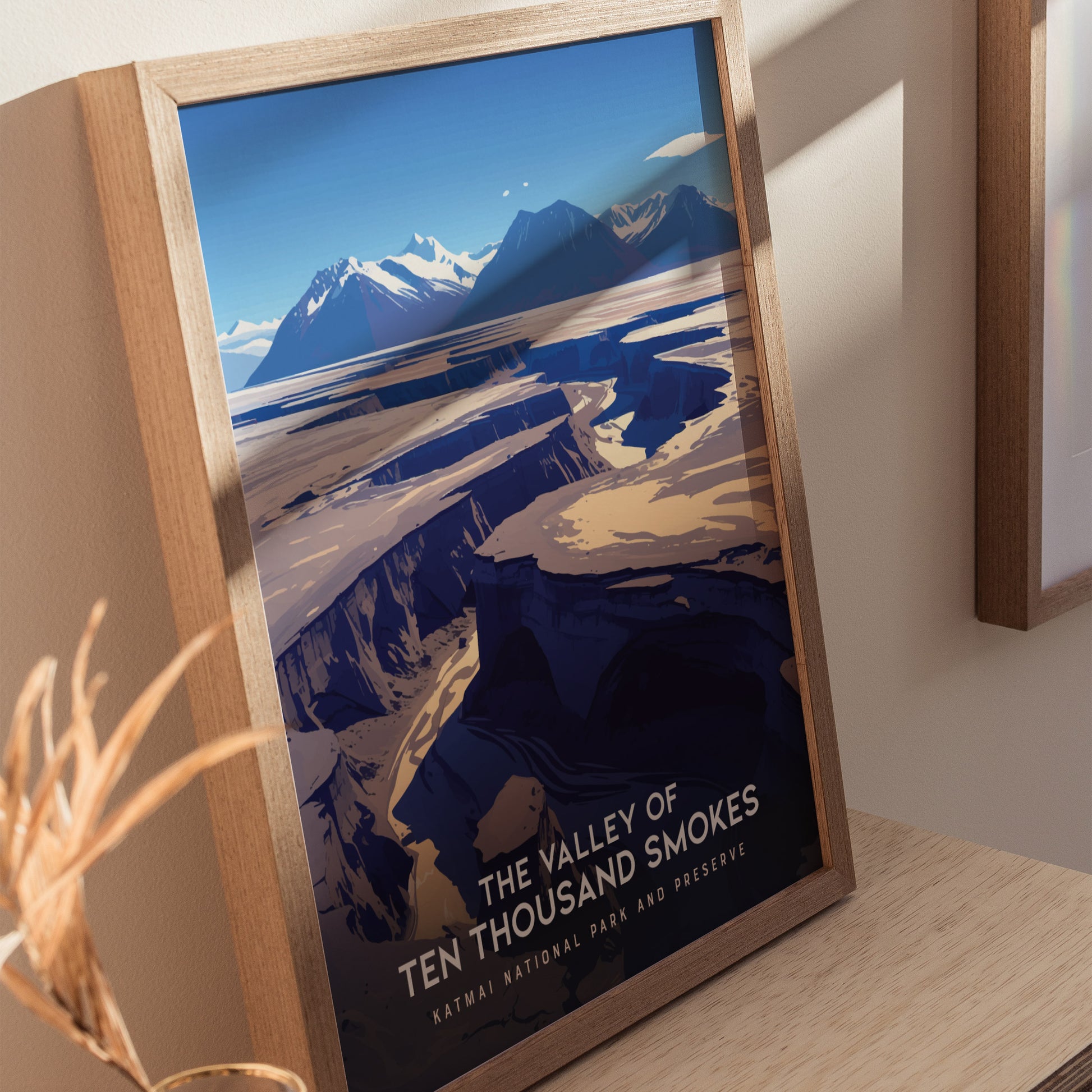 Framed poster of the Valley of Ten Thousand Smokes features dramatic ash-covered valleys and distant snow-capped mountains, highlighting the volcanic landscape of Katmai National Park.