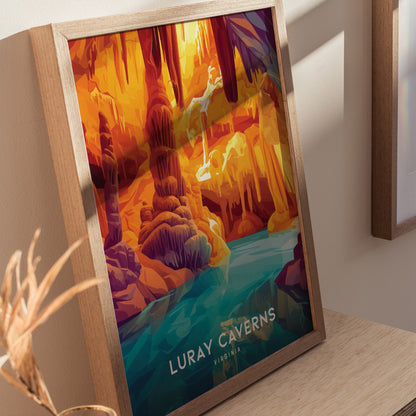 Framed poster of Luray Caverns in vivid colors, depicting intricate stalactites and a reflective pool, leaning against a light wall on a wooden surface.