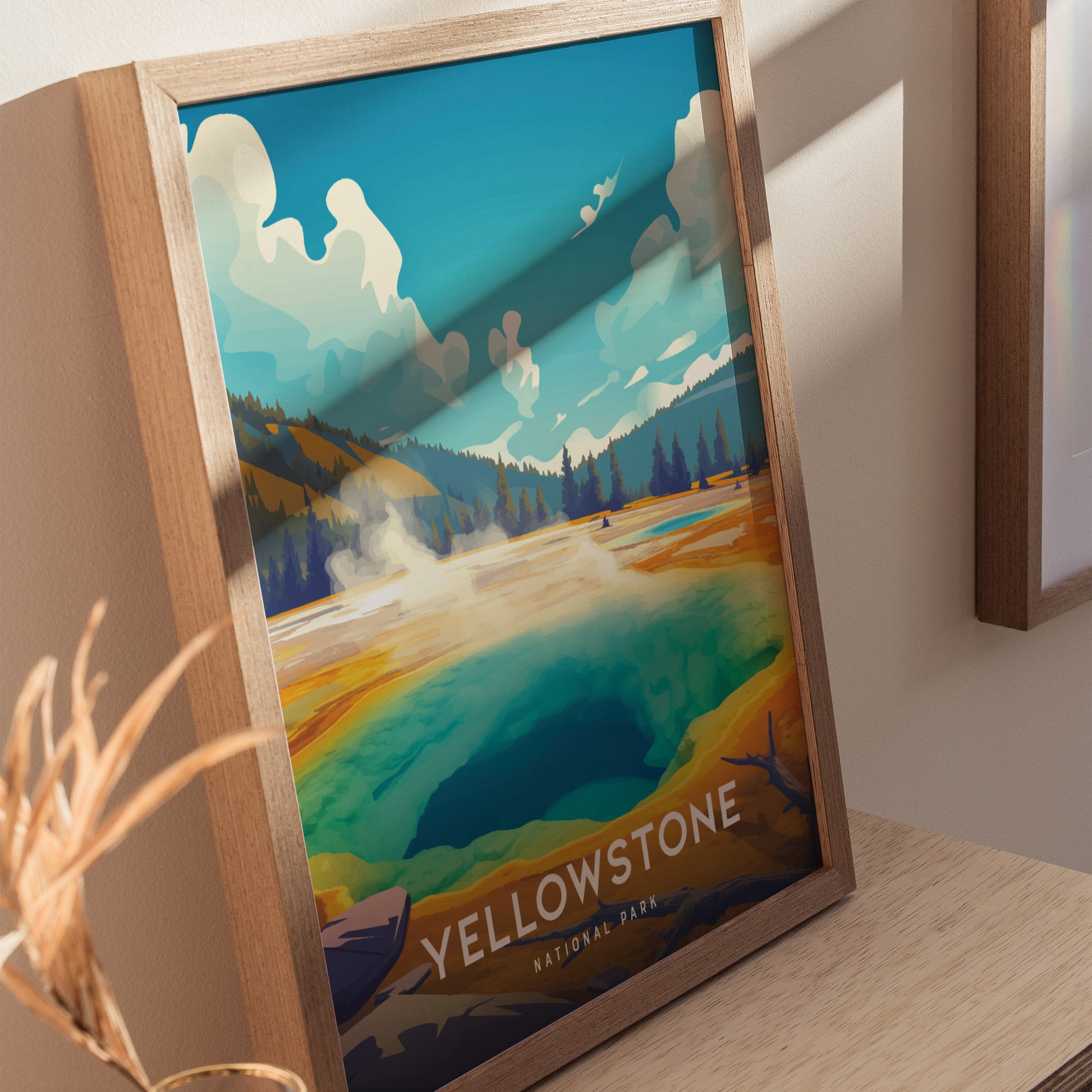 A framed illustration of Yellowstones Morning Glory Pool features vibrant colors with a turquoise center, surrounded by golden hues and a scenic landscape under a blue sky.