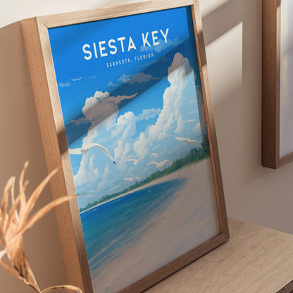 A framed poster of Siesta Key, Florida, featuring a vibrant beach scene with turquoise water, white sand, and soaring seagulls under a blue sky with fluffy clouds.