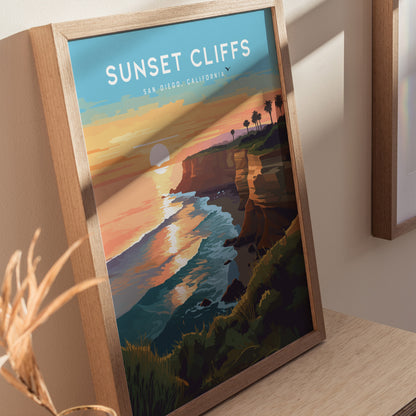 Framed artwork titled Sunset Cliffs depicts a vibrant sunset over ocean waves and cliffs in San Diego, California. The scene includes silhouetted palm trees and a glowing horizon.