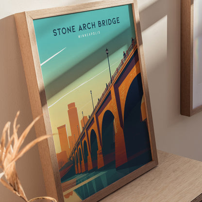 Framed poster depicting the Stone Arch Bridge in Minneapolis, with an orange and blue color scheme and the city skyline in the background.