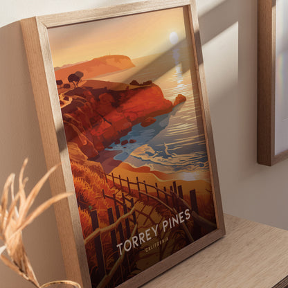 Framed artwork depicting Torrey Pines, California, features vibrant orange cliffs, a winding coastal trail, and a serene ocean view under a setting sun.