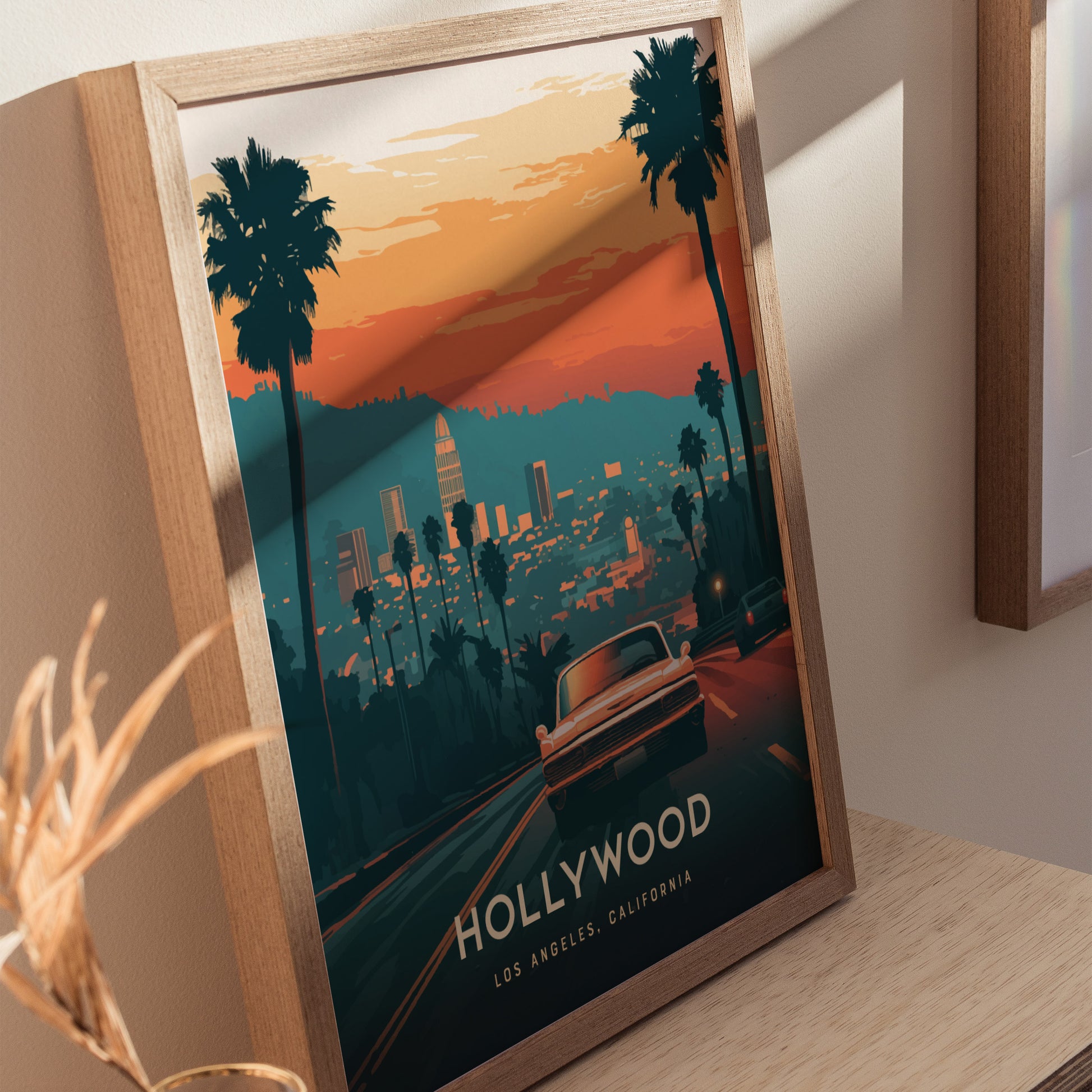 A framed poster features a stylized view of Los Angeles with palm trees, a classic car, and a sunset skyline, labeled Hollywood Los Angeles, California.