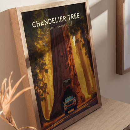 Framed poster of the Chandelier Tree in Leggett, California, depicting a car driving through the tunnel carved in the massive redwood. Warm sunlight filters through the forest canopy.