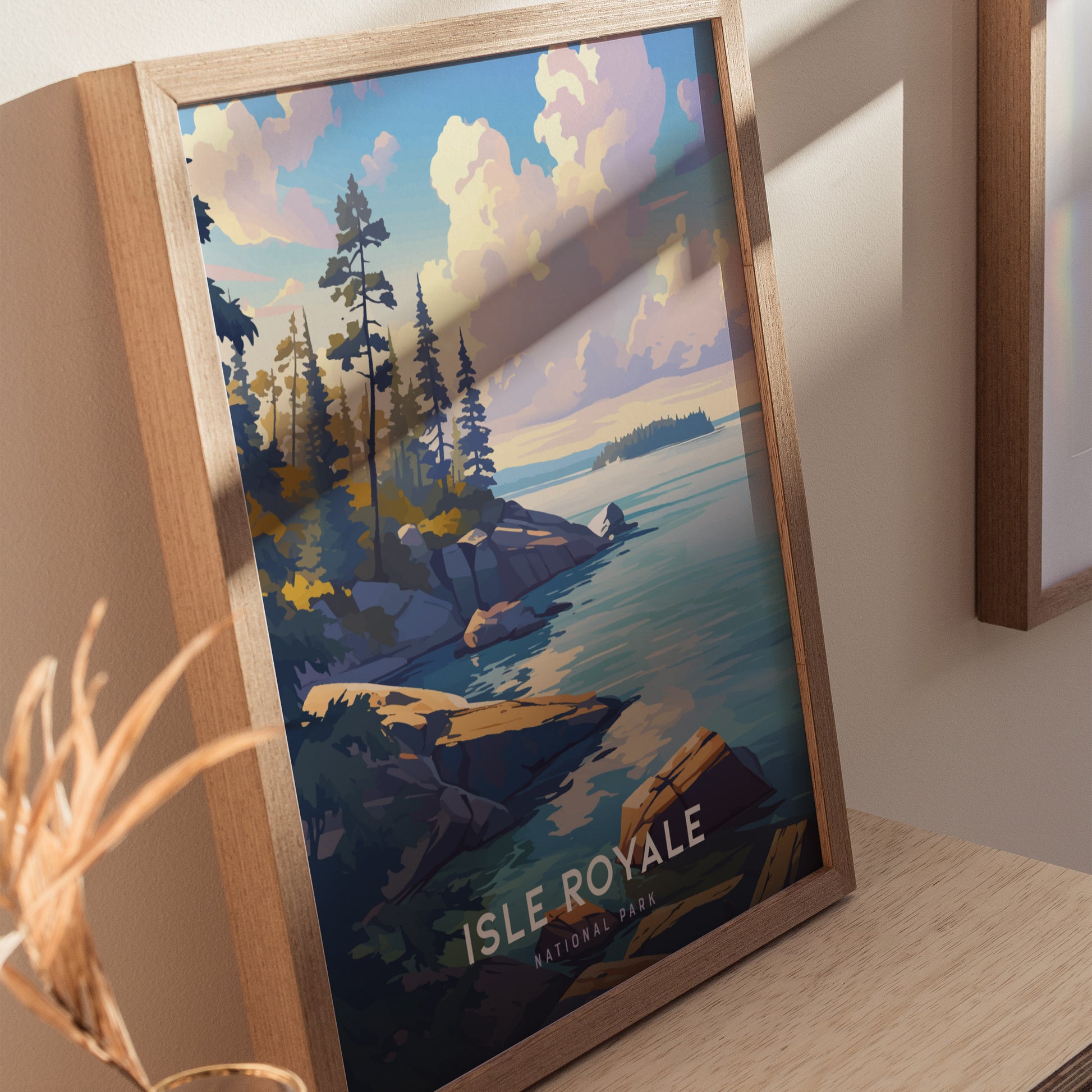 Framed poster of Isle Royale National Park showcasing a scenic view of rocky shorelines, pine trees, and a serene lake under a cloudy sky.
