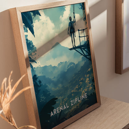 Framed artwork depicting a person on a zipline platform overlooking a lush rainforest and Arenal Volcano in the distance, titled Arenal Zipline, Costa Rica.