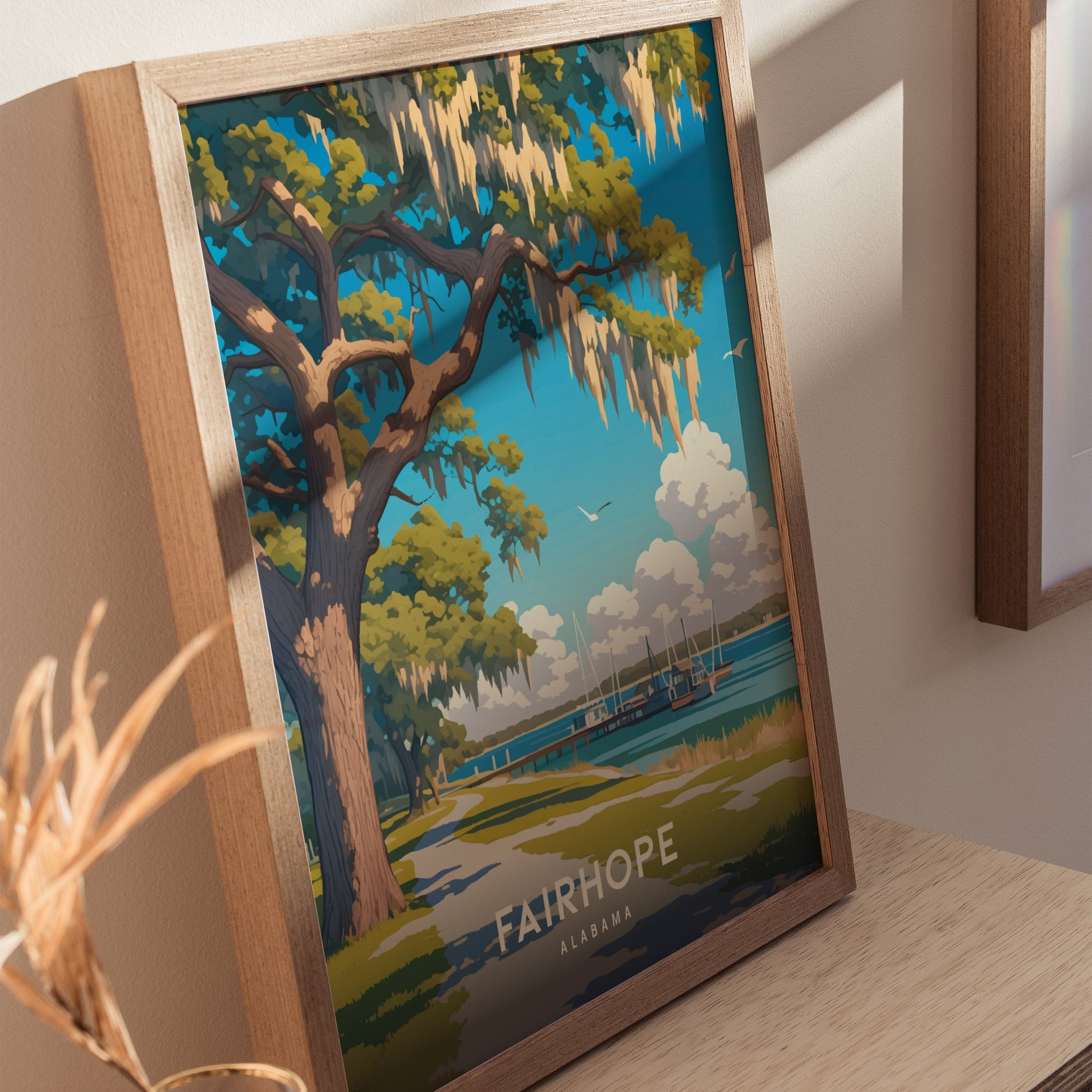 Framed poster featuring a Southern live oak tree with Spanish moss, overlooking Mobile Bay in Fairhope, Alabama. The artwork includes a vibrant blue sky and distant sailboats.