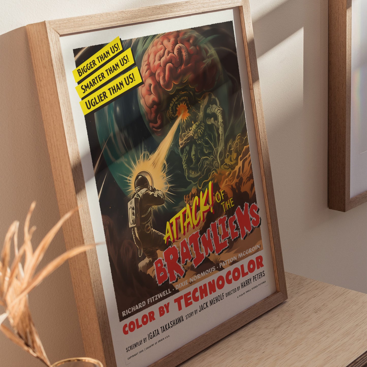 Home decor showing framed and unframed wall art posters depicting chaotic alien invasion and retro sci-fi elements.