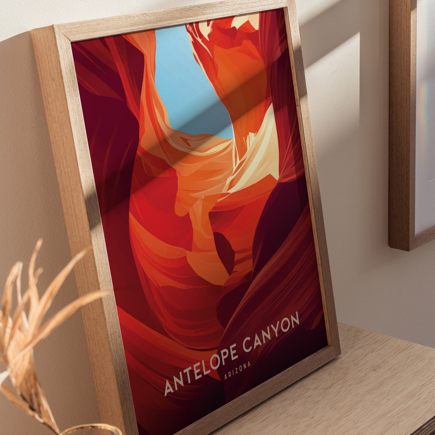 Framed Antelope Canyon poster featuring vibrant red and orange sandstone formations with a hint of blue sky, placed on a wooden surface, casting a soft shadow.