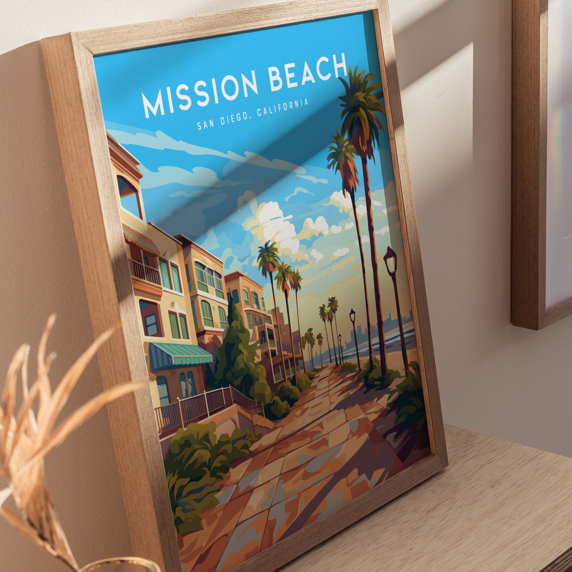 Framed poster of Mission Beach, San Diego, featuring a vibrant boardwalk scene with palm trees, colorful buildings, and a bright blue sky.