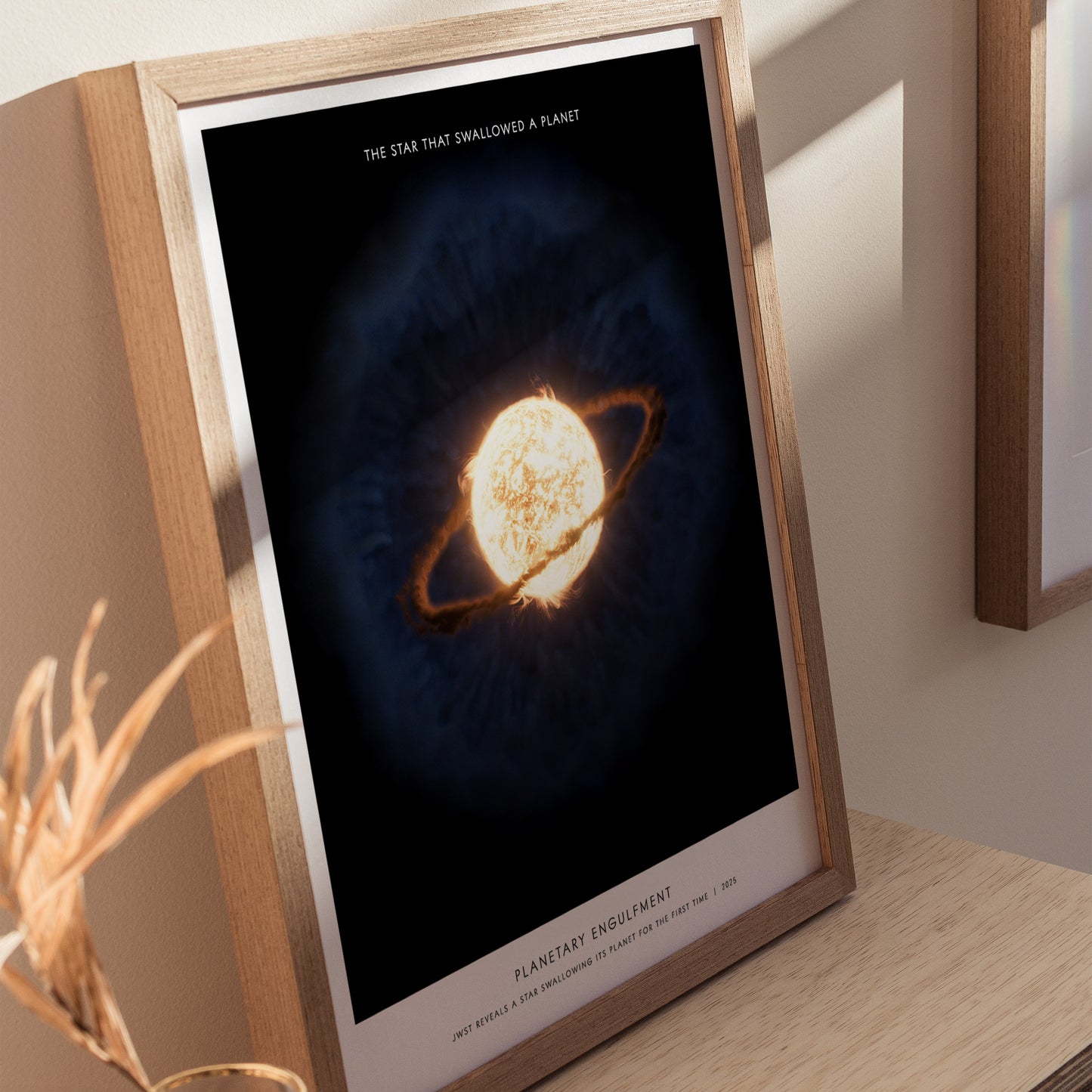 Natural wood framed Planetary Engulfment space print leaning on a shelf next to plants and neutral accessories