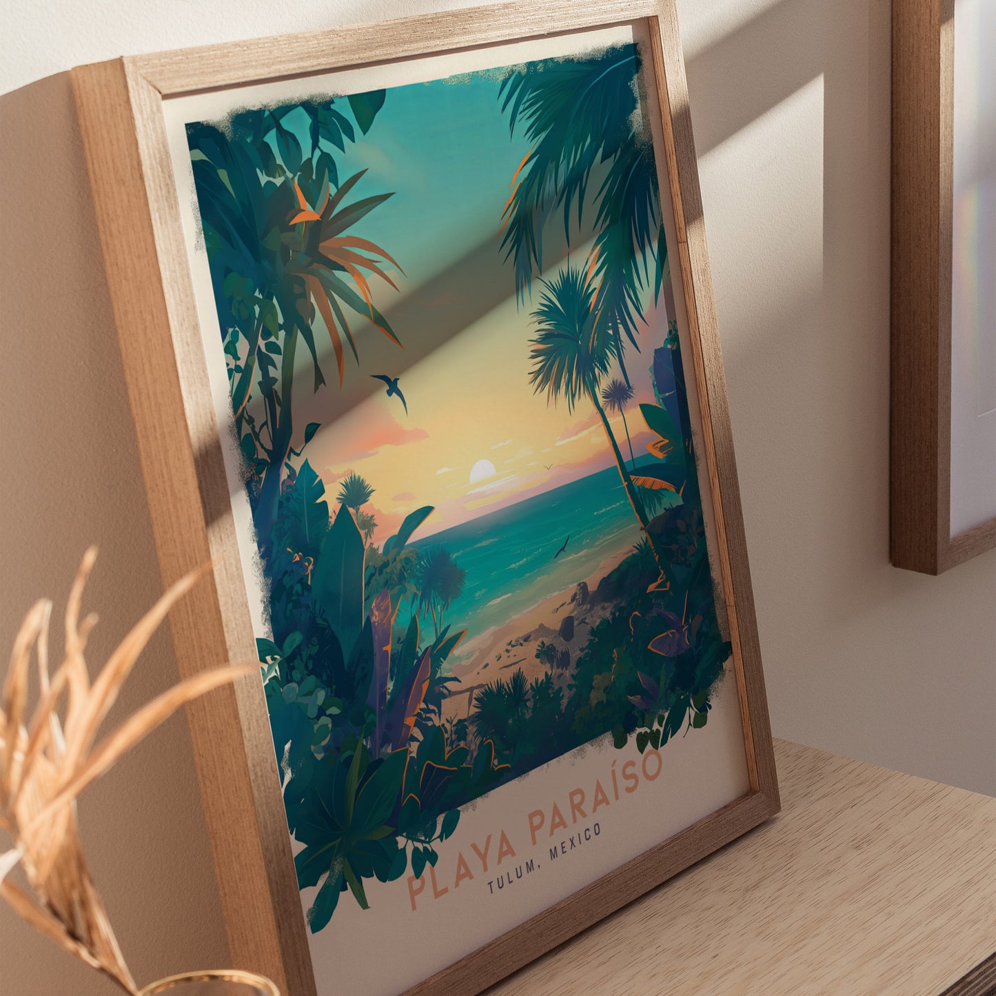 Framed artwork of a tropical beach scene at sunset, featuring palm trees and colorful foliage, with Playa Paraiso, Tulum, Mexico written at the bottom. Bright sunlight casts shadows.