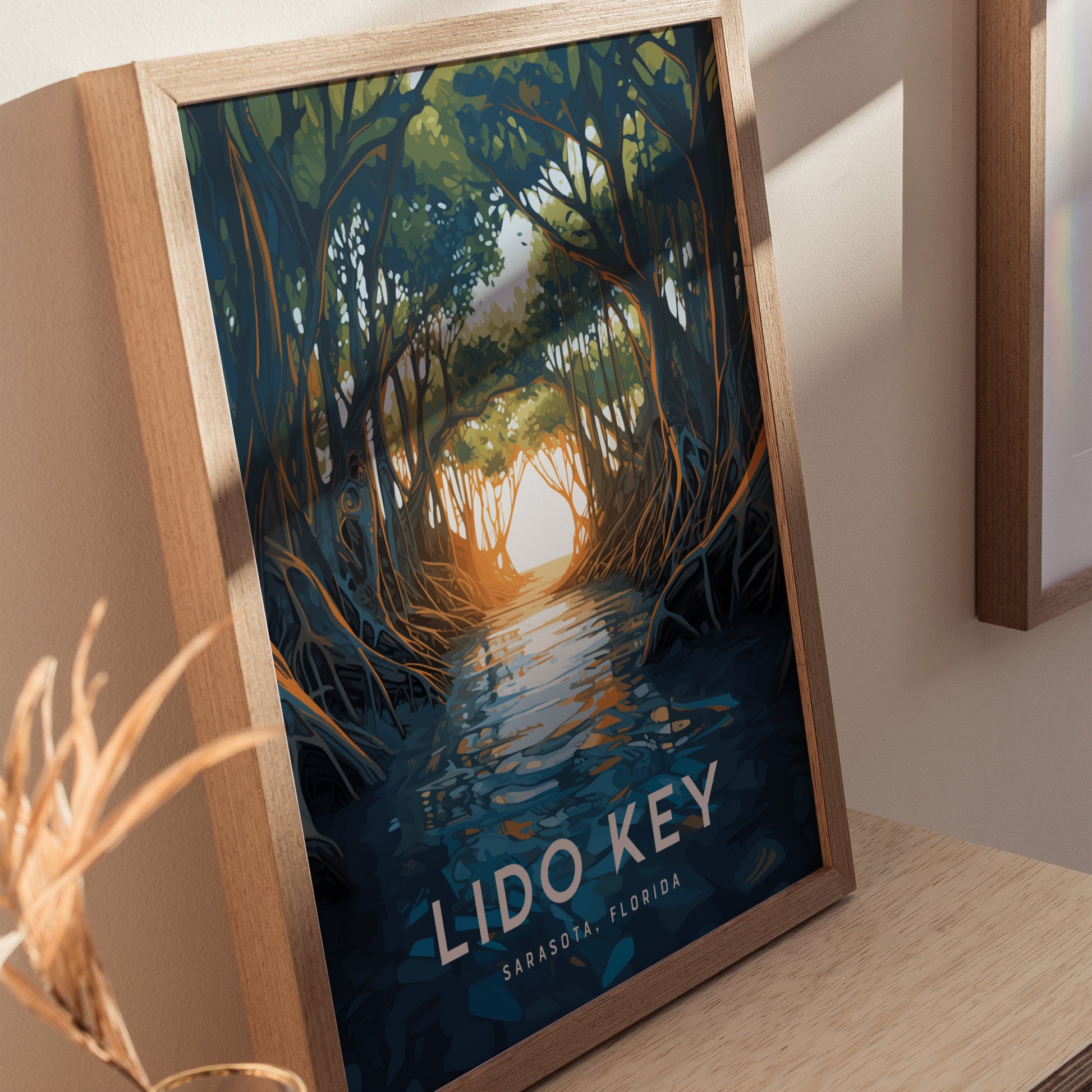 Framed illustration of mangroves with arching canopies and sunlit water, titled Lido Key, Sarasota, Florida. The poster is leaning on a wooden surface, creating a serene coastal ambiance.