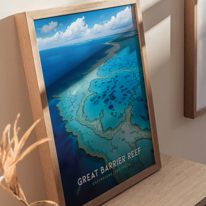 Framed poster of the Great Barrier Reef showcasing vibrant turquoise waters and intricate coral patterns, with text reading Great Barrier Reef, Queensland, Australia. Displayed on a wooden table.