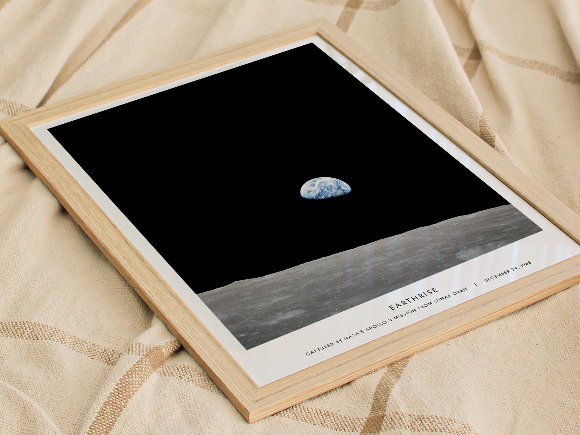 Framed photograph of Earth from space on a textured fabric background