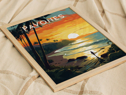 A framed poster depicting a vibrant sunset over a tropical beach with palm trees and a lone surfer walking along the shore, placed on a textured fabric surface.