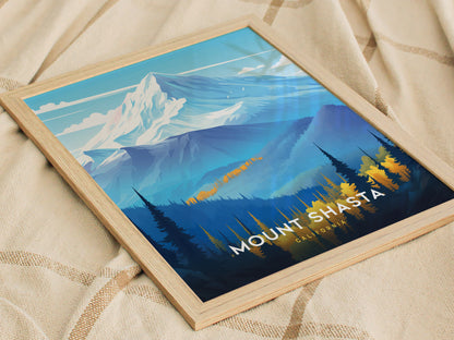 A framed poster of Mount Shasta featuring stylized snow-capped peaks and forested foothills, resting on a beige textured blanket. The text reads Mount Shasta, California.