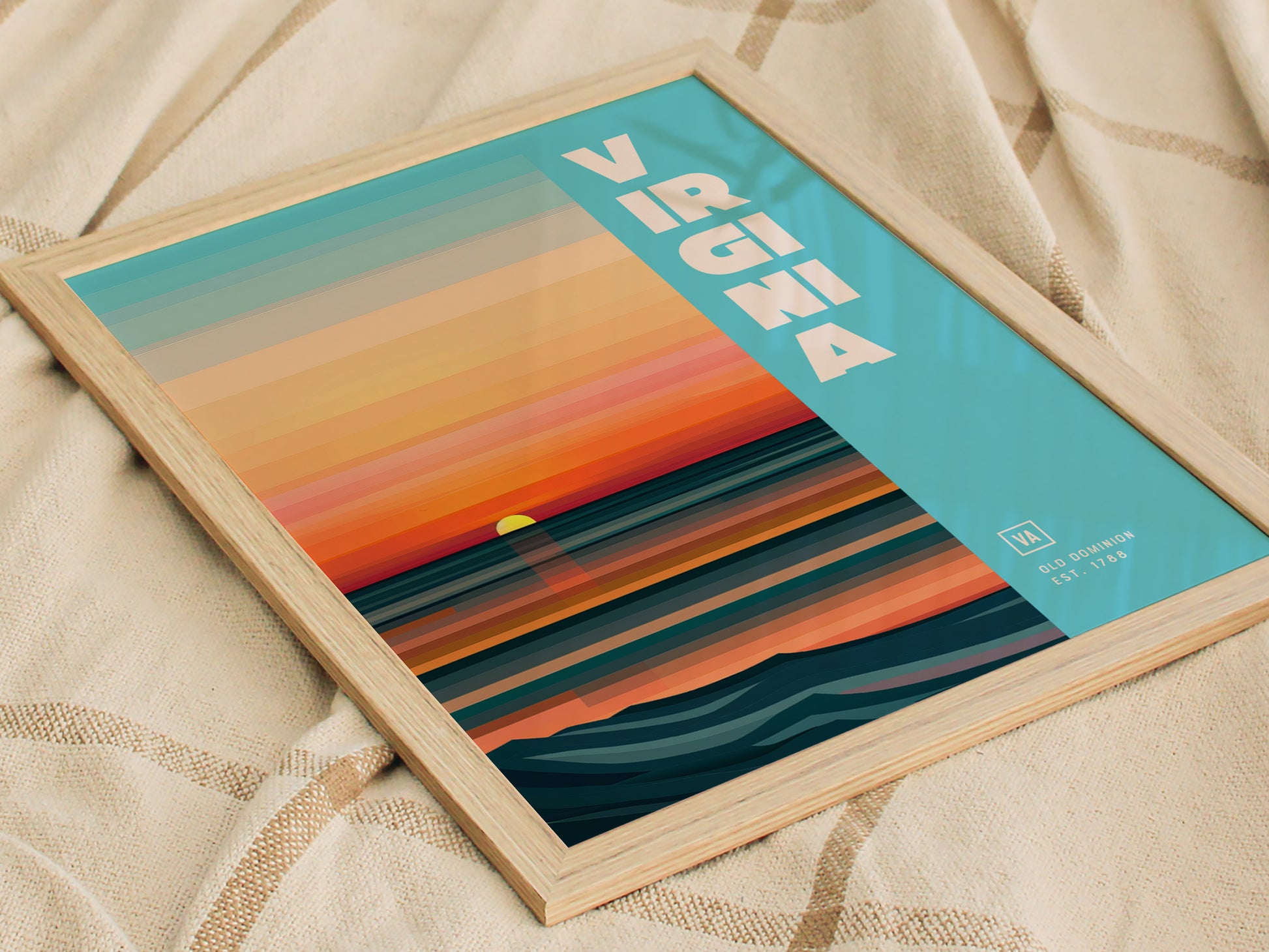 A framed poster with a sunset design featuring horizontal stripes in orange, blue, and teal. Virginia is written in bold white letters on a light blue background.