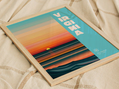A framed poster with a sunset design featuring horizontal stripes in orange, blue, and teal. Virginia is written in bold white letters on a light blue background.