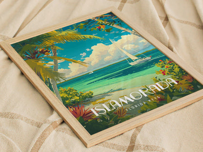 Framed Islamorada poster featuring a vibrant coastal scene with turquoise waters, a sailboat, palm trees, and colorful foliage, resting on a textured fabric surface.