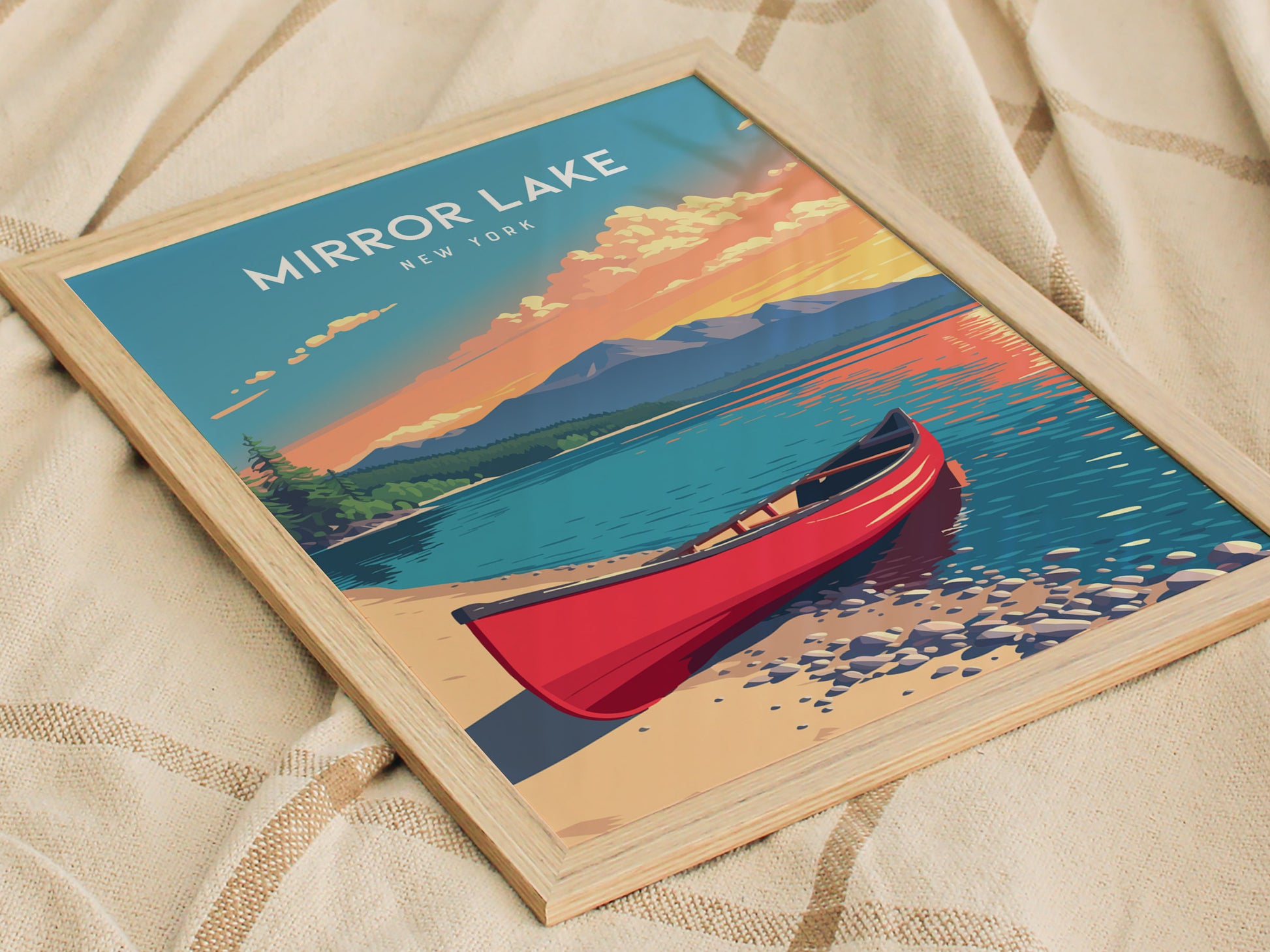 A framed poster of Mirror Lake, New York, featuring a vibrant illustration of a red canoe on the shore. The scene showcases the lakes calm waters reflecting colorful mountains and a sunset sky, creating a serene atmosphere.