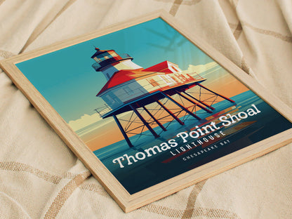 A framed poster of the Thomas Point Shoal Lighthouse, featuring vibrant colors and bold design, rests on a textured beige fabric surface. The text highlights its location in Chesapeake Bay.