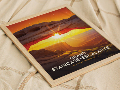 Framed poster of Grand Staircase-Escalante featuring a vibrant sunset arch with sun rays, set on a textured fabric background. The image showcases a dramatic landscape in warm hues.