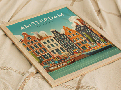 Framed poster of Amsterdam canals with colorful historic buildings and boats, set against a blue sky, resting on a beige patterned fabric.